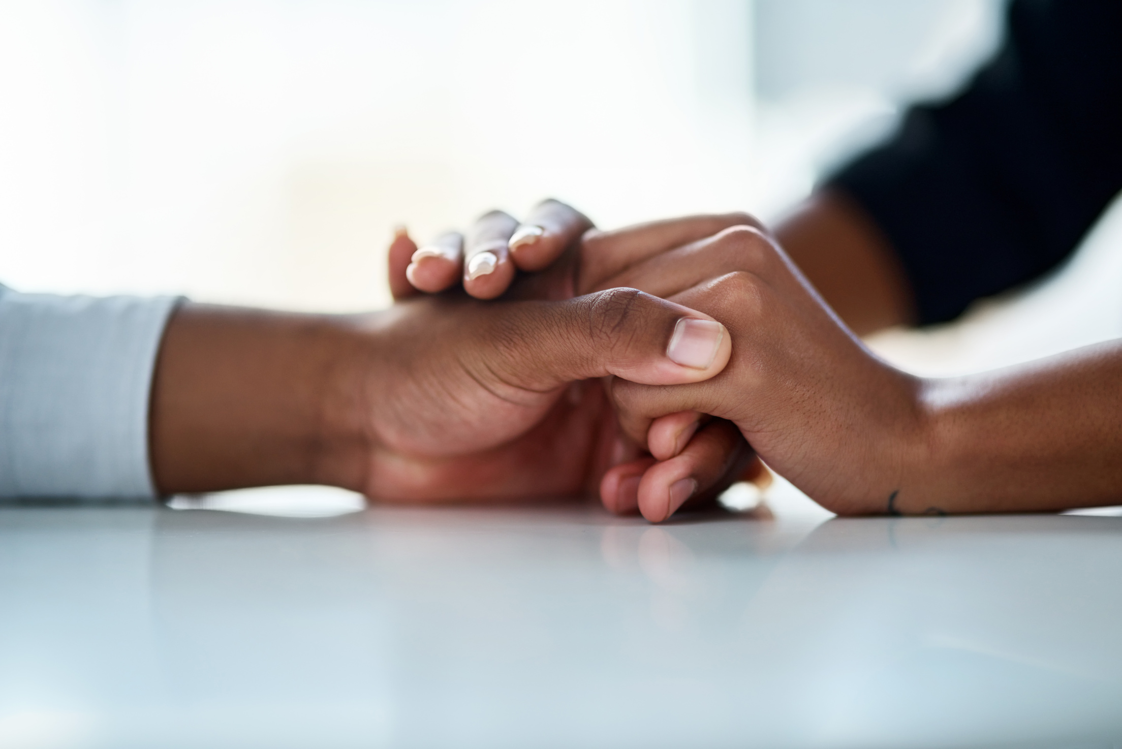 You Are Not Alon. Cropped of Two Unrecognizable People Holding H